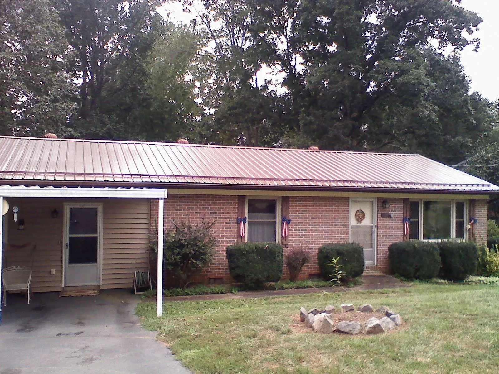 Bronze metal roof and carport on a brick ranch home — Roof Repair work by our crew in Rocky Hill